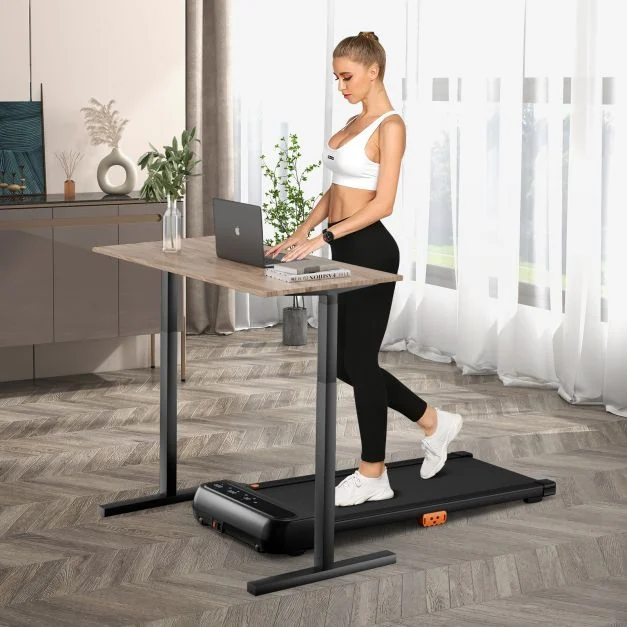 Woman walking on a Toputure TP8 incline walking pad while working at a standing desk